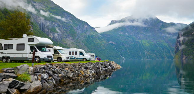 Motor Homes at the edge of a lake with mountains in the background